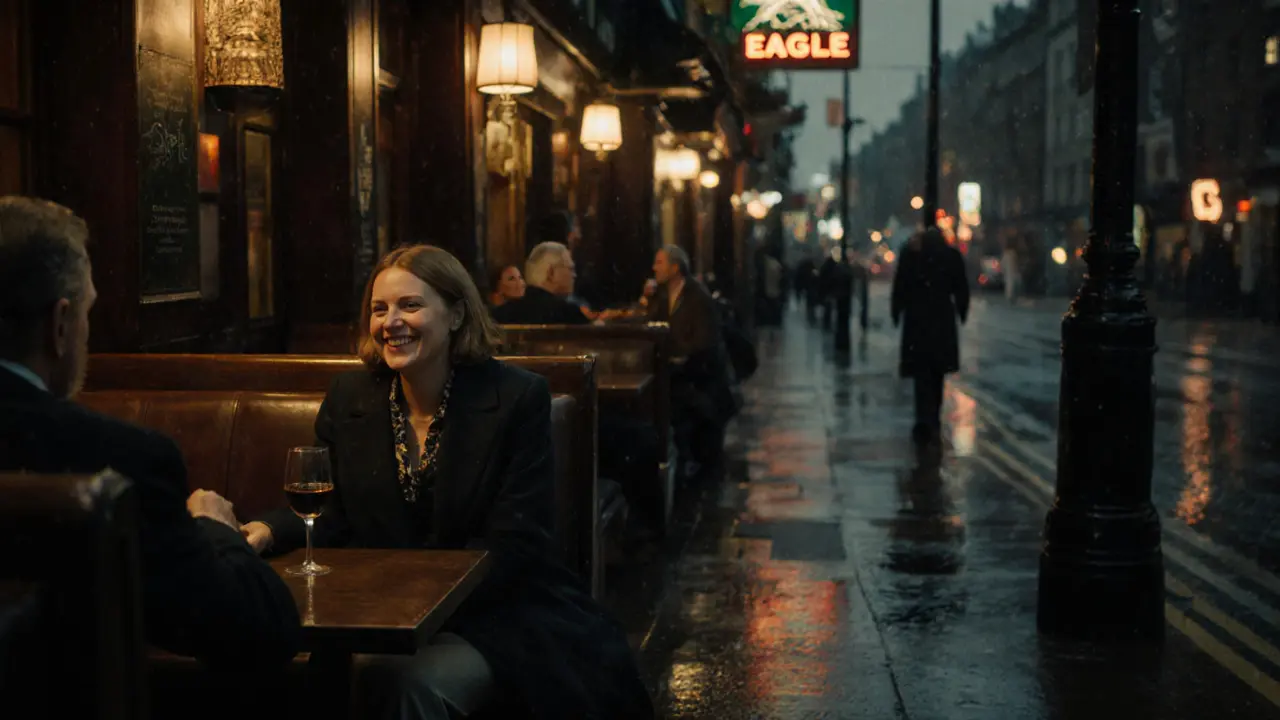 A historic Soho pub at night with patrons chatting warmly under soft lighting.