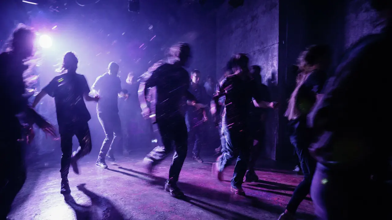 Dancers moving on Fabric nightclub&#039;s floor under pulsing lights, no phones, pure rhythm and motion.