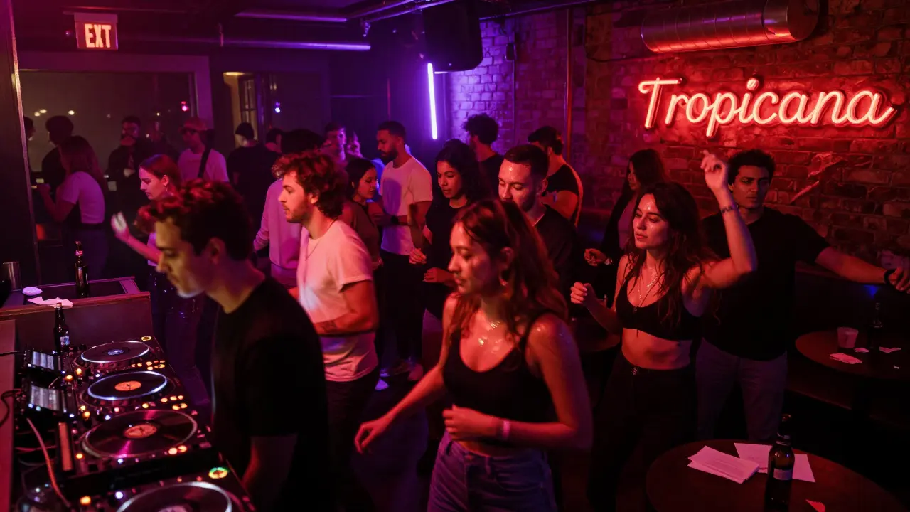 Crowded nightclub dance floor with neon lights and people dancing to house music late at night.
